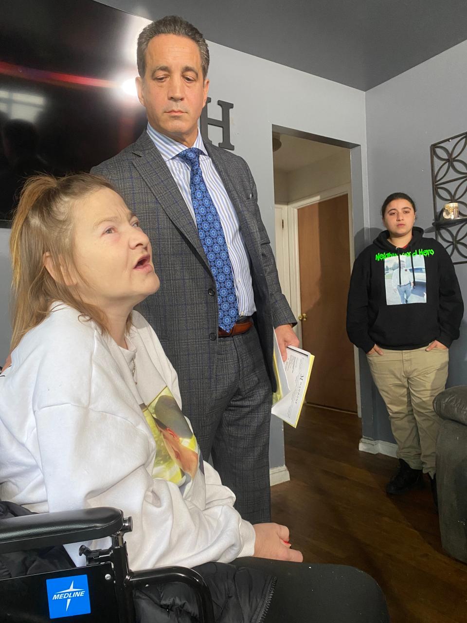 Andrew Edelmann's mother, Melissa, (left) speaks at a press conference demanding police body-cam video be released of her son's fatal shooting by a New Castle County Police officer on March 6, 2023. The family attorney, Joseph Marrone, stands next to her, while Aida Pabon (right) stands in the background, Pabon was also shot that night, but survived.