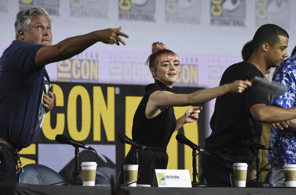 Conleth Hill, from left, Maisie Williams and Jacob Anderson throw their name card to the audience at the conclusion of the "Game of Thrones" panel on day two of Comic-Con International on Friday, July 19, 2019, in San Diego. (Photo by Chris Pizzello/Invision/AP)