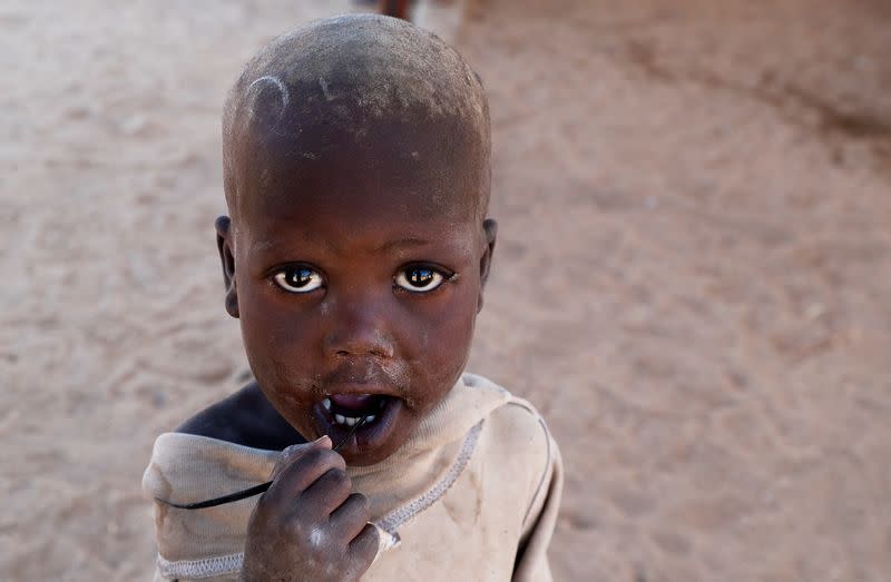 A child from the Turkana pastoralist community affected by the worsening drought due to failed rain seasons, looks on at an open classroom under a tree at the Sopel Primary School in Sopel village in Turkana