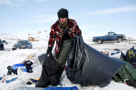 Crystal Houser, 30, of Klamath Falls, Oregon, bags excess blankets for delivery to nearby communities while helping to clean up the opposition camp against the Dakota Access oil pipeline near Cannon Ball, North Dakota, U.S., February 8, 2017. REUTERS/Terray Sylvester