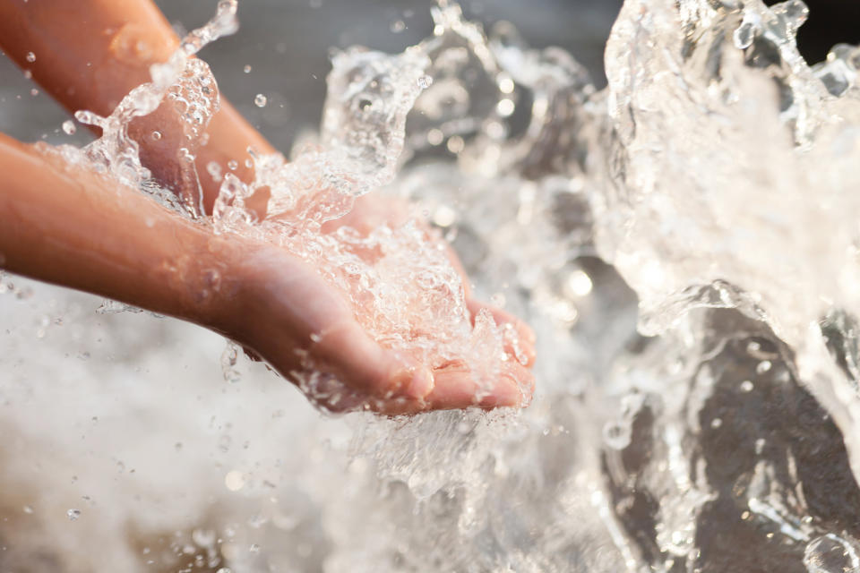 Hands cupped in splashing water