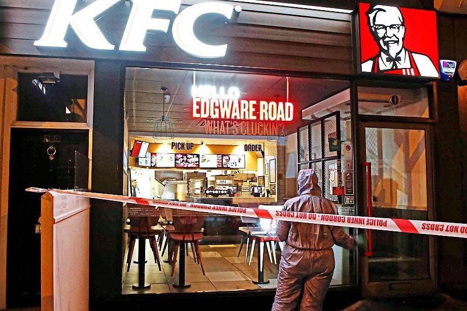 Forensic officers gather evidence outside the KFC following the stabbing (NIGEL HOWARD)