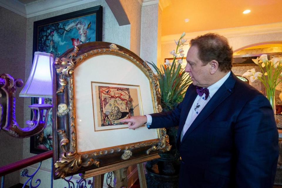 Dr. Christopher Heath Brown shows a drawing by Salvador Dalí of the painting “Cartel de Don Juan Tenorio,” which is most famous for being stolen from the Venus Over Manhattan gallery in New York City, then mailed back to the gallery from Greece a week later in 2012.