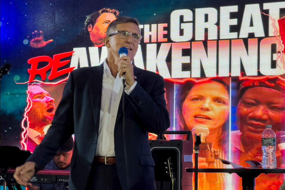 Michael Flynn, a retired three-star general who served as Trump's national security adviser, speaks on stage during the ReAwaken America tour at Cornerstone Church, in Batavia, N.Y., Friday, Aug. 12, 2022. Thousands of people gathered to hear his message that the nation is facing an existential threat, and to save it, his supporters must act. (AP Photo/Carolyn Kaster)