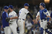Los Angeles Dodgers' Shohei Ohtani, center, greets catcher Will Smith after the team's win over the Miami Marlins in a baseball game Tuesday, May 7, 2024, in Los Angeles. (AP Photo/Marcio Jose Sanchez)
