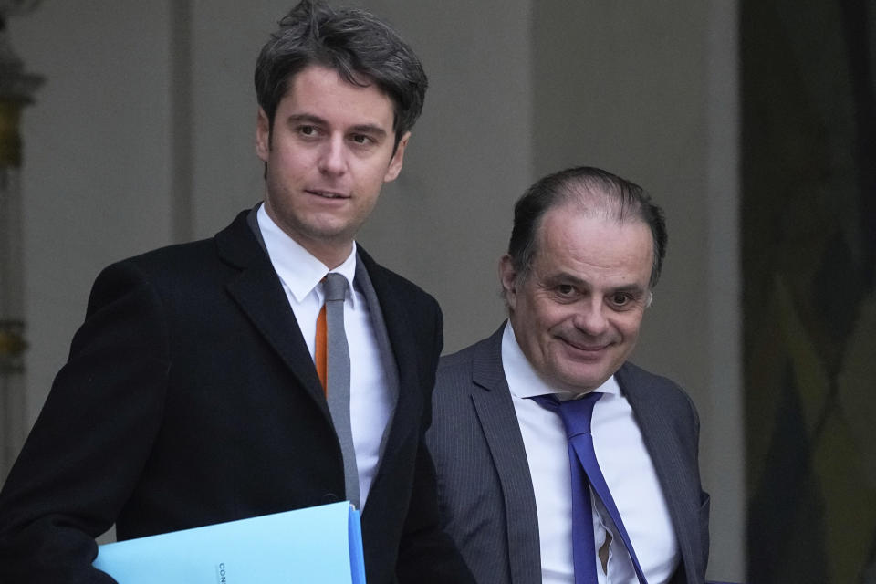 New French prime minister Gabriel Attal, left, and chief of staff of French Prime Minister Emmanuel Moulin, leave the weekly cabinet meeting after a cabinet reshuffle, Friday, Jan. 12, 2024 at the Elysee Palace in Paris. (AP Photo/Michel Euler)