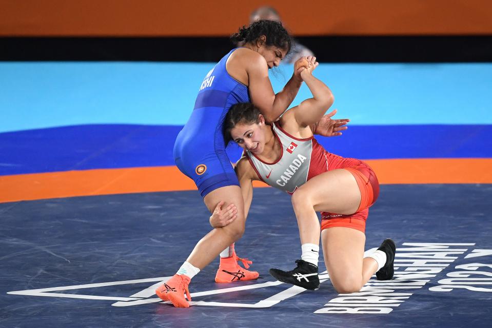 COVENTRY, ENGLAND - AUGUST 05: Sakshi Malik (blue) of Team India competes against Ana Godinez Gonzalez (red) of Team Canada during the women's 62 kg freestyle gold medal match on day eight of the Birmingham 2022 Commonwealth Games on August 5, 2022 in Coventry, England.  (Photo by Tom Dulat/Getty Images)