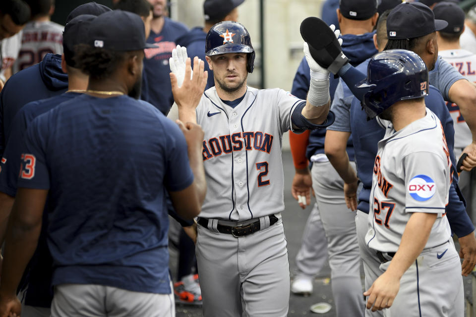 Houston Astros third baseman Alex Bregman (2) celebrates in the dug out after hitting a two-run home run against the Detroit Tigers in the fifth inning of a baseball game, Saturday, Aug. 26, 2023 in Detroit. (AP Photo/Lon Horwedel)