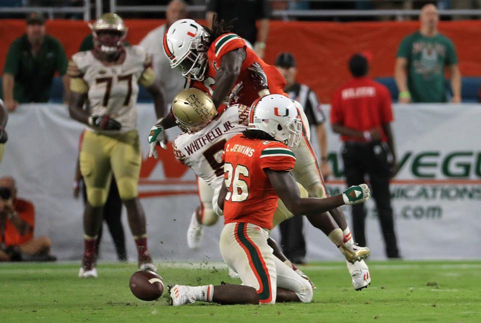 MIAMI GARDENS, FL – OCTOBER 08: Jamal Carter Sr. #6 of the Miami Hurricanes hits Kermit Whitfield #8 of the Florida State Seminoles for a personal foul during a game at Hard Rock Stadium on October 8, 2016 in Miami Gardens, Florida. (Photo by Mike Ehrmann/Getty Images)