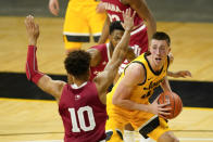 Iowa guard Joe Wieskamp, right, drives around Indiana guard Rob Phinisee (10) during the first half of an NCAA college basketball game, Thursday, Jan. 21, 2021, in Iowa City, Iowa. (AP Photo/Charlie Neibergall)
