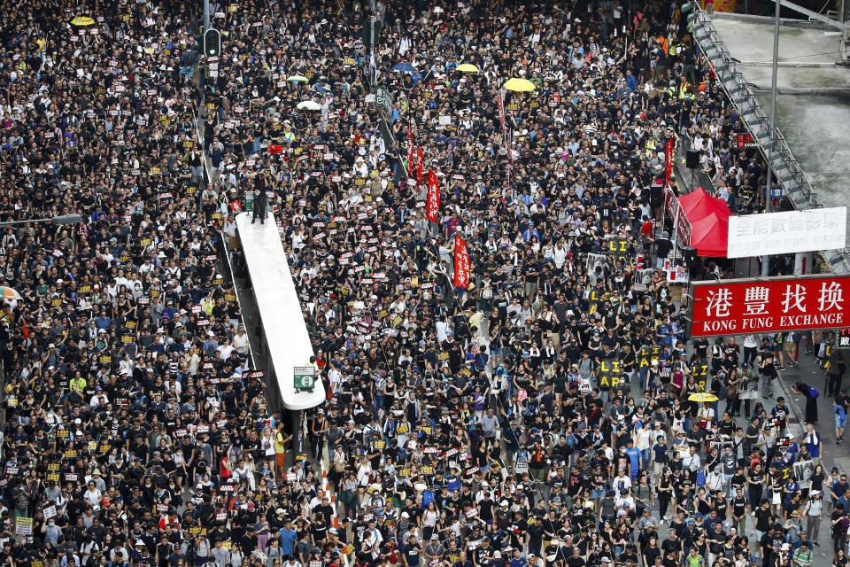 FILE - In this July 21, 2019, file photo, protesters take part in a march on a street in Hong Kong. Hong Kong's protest movement has reached a moment of reckoning after protesters occupying the airport held two mainland Chinese men captive, and pro-democracy lawmakers and fellow demonstrators question whether the whole operation has gone too far. (AP Photo/Vincent Yu, File)