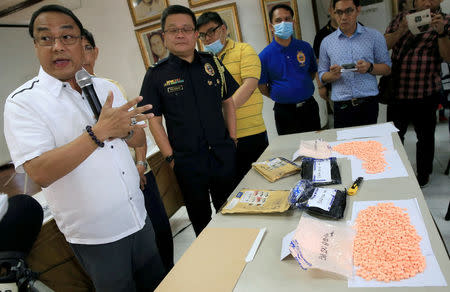 Philippine Drug Enforcement Agency (PDEA) National Capital Region Director Wilkins Villanueva (L) briefs other officials and members of the media regarding the intercepted parcels containing an estimated three million pesos (US$ 64,000) worth of ecstasy from Germany at the Ninoy Aquino International Airport by agents from the customs anti-illegal drugs task force, during a news briefing at the Bureau of Customs headquarters in Pasay City, metro Manila, Philippines August 24, 2016. REUTERS/Romeo Ranoco/File Photo