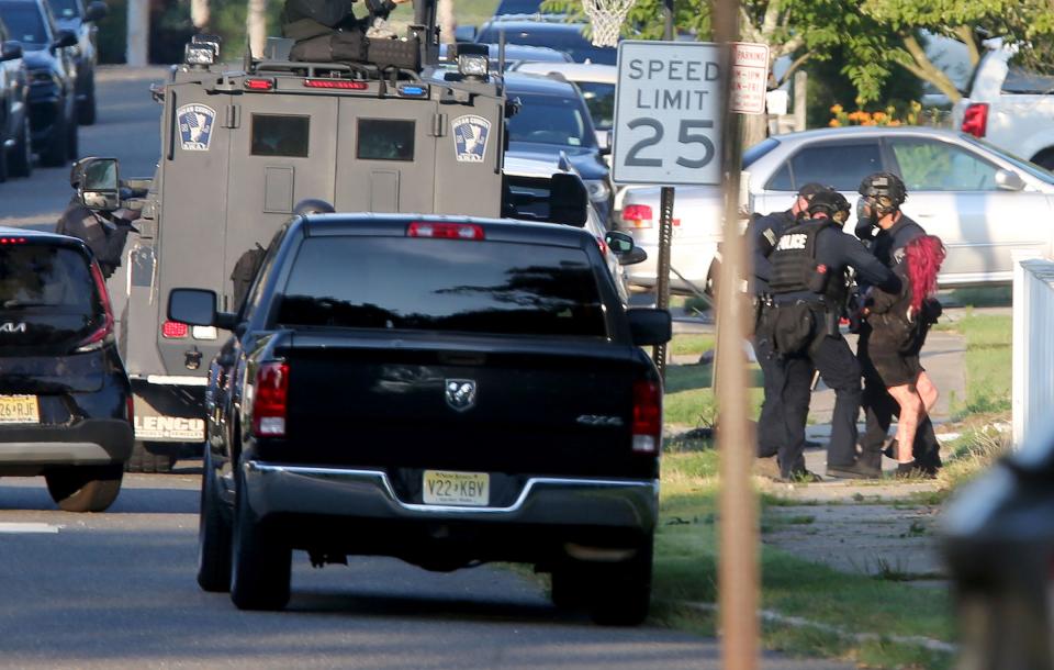 A red haired woman who emerged from the Ravenwood Drive home Friday afternoon, July 5, 2024, where Maxwell Johnston had been barricaded is taken into custody by SWAT officers. Johnston is the suspect in the slaying of Gabriella Caroleo in Manchester.