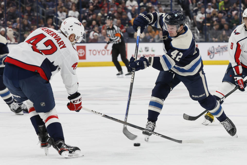 Columbus Blue Jackets' Alexandre Texier, right, shoots the puck past Washington Capitals' Martin Fehervary during the second period of an NHL hockey game Thursday, Dec. 21, 2023, in Columbus, Ohio. (AP Photo/Jay LaPrete)