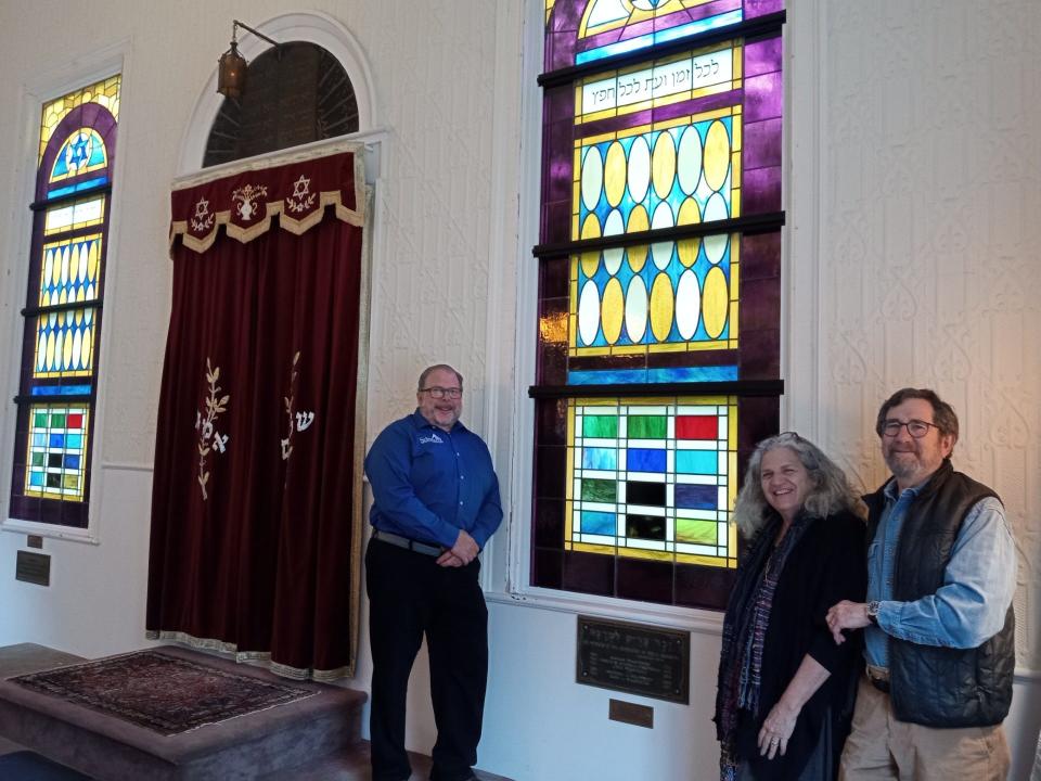 Two new stained-glass windows have been installed at Congregation Beth Israel in Honesdale for the congregation's 175th anniversary in 2024. There had not been stained-glass windows in the synagogue since they were destroyed in the 1942 flood. From left are Robert Schwartz of the congregation's board of directors, and the designer and craftsman who made the windows, Nancy Katz and Mark Liebowitz of Wilmark Studios in Pawtucket, Rhode Island.