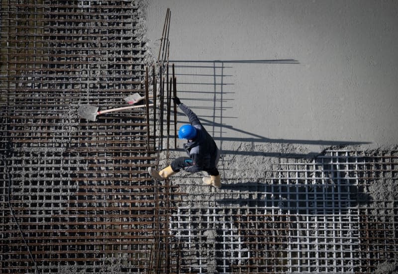 A worker is busy on a construction site at Alexanderplatz. The Macroeconomic Policy Institute (IMK), part of the trade union-affiliated Hans Boeckler Foundation, predicted German gross domestic product (GDP) to shrink by 0.3% in 2024. Soeren Stache/dpa
