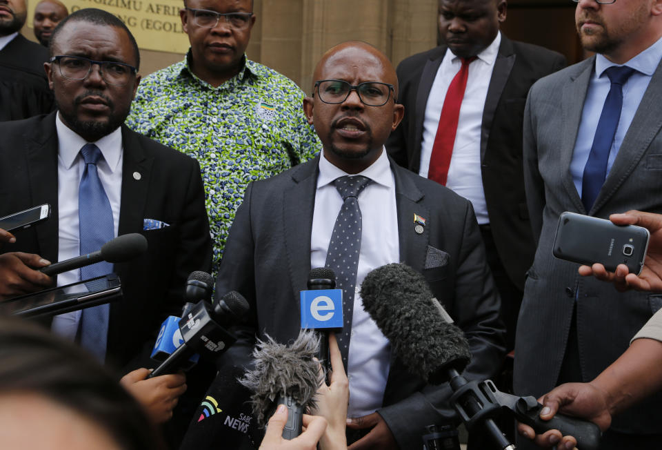 Nelson Mandela Foundation's CEO, Sello Hatang, speaks to the press on the steps of the Johannesburg High Court, Wednesday, August 21, 2019. South Africa's Equality Court has restricted the display of the old apartheid-era flag in a ruling issued Wednesday Aug. 21, 2019, that it's gratuitous use amounts to hate speech and racial discrimination. (AP Photo/Denis Farrell)