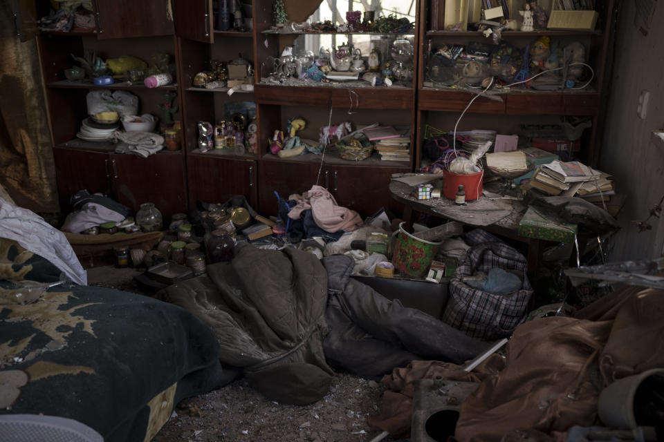 The body of a civilian lies in an apartment as Russian bombardments continue in a village recently retaken by Ukrainian forces near Kharkiv, Ukraine, Saturday, April 30, 2022. (AP Photo/Felipe Dana)