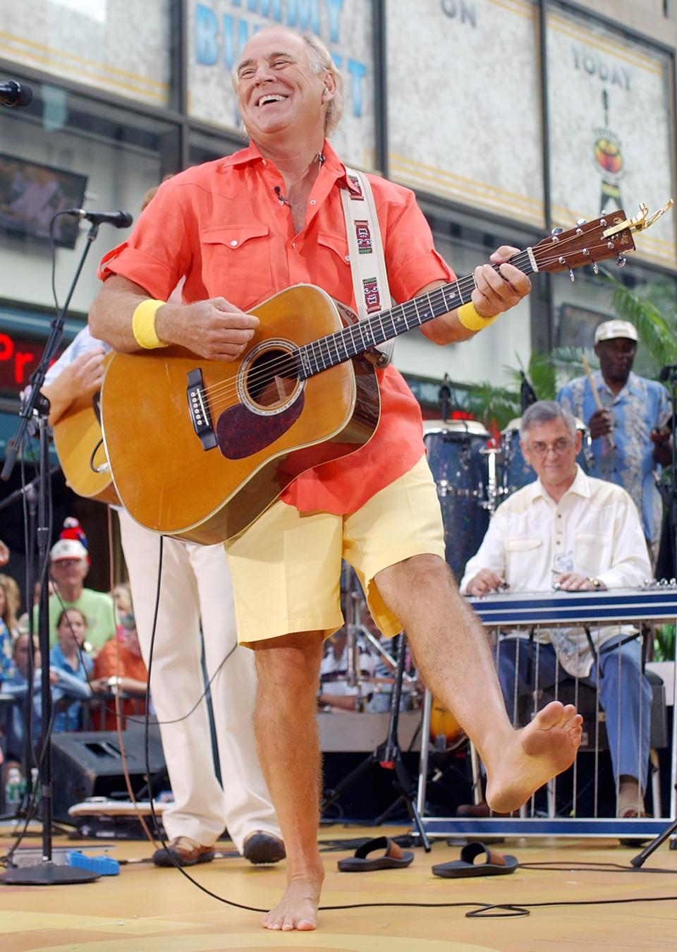 Singer Jimmy Buffett performs barefooted with his band The Coral Reefers on the NBC "Today" television show summer concert series in New York's Rockefeller Plaza, on June 25, 2004. “Margaritaville” singer-songwriter Jimmy Buffett has died at age 76.