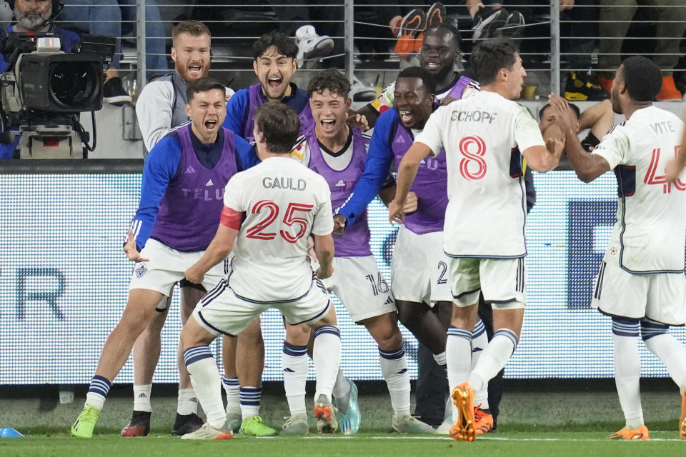 Vancouver Whitecaps midfielder Ryan Gauld (25) celebrates with teammates after scoring during the second half of an MLS soccer match against Los Angeles FC in Los Angeles, Saturday, June 24, 2023. (AP Photo/Ashley Landis)