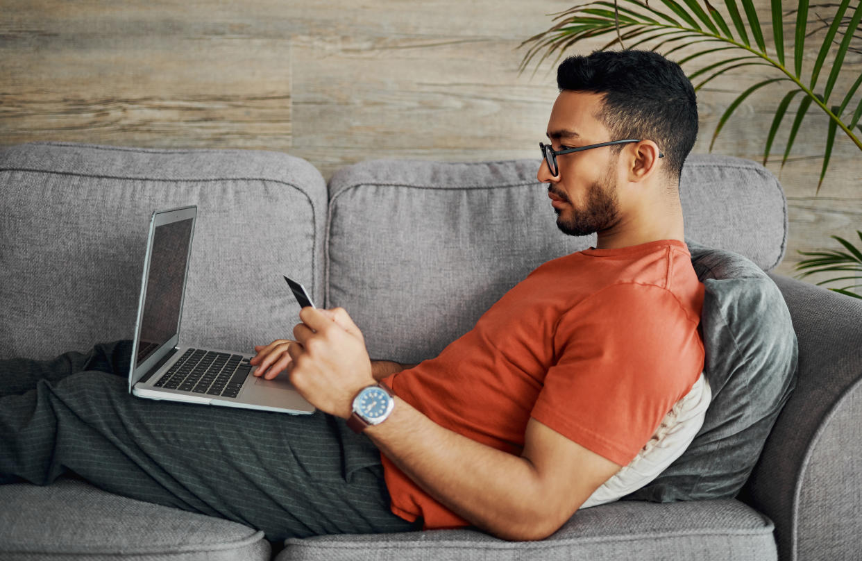 Man on sofa using laptop