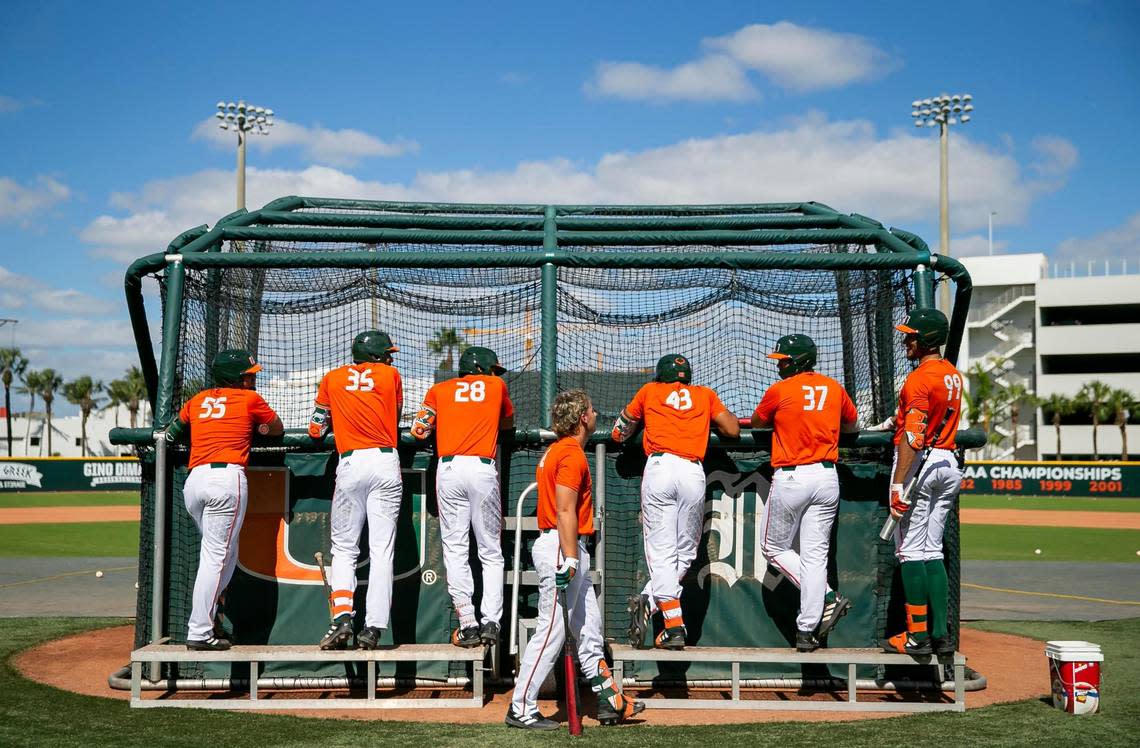 Miami Hurricanes wait for their batting turn during practice at Mark Light Field on Tuesday, Feb. 14, 2023, in Coral Gables, Fla.