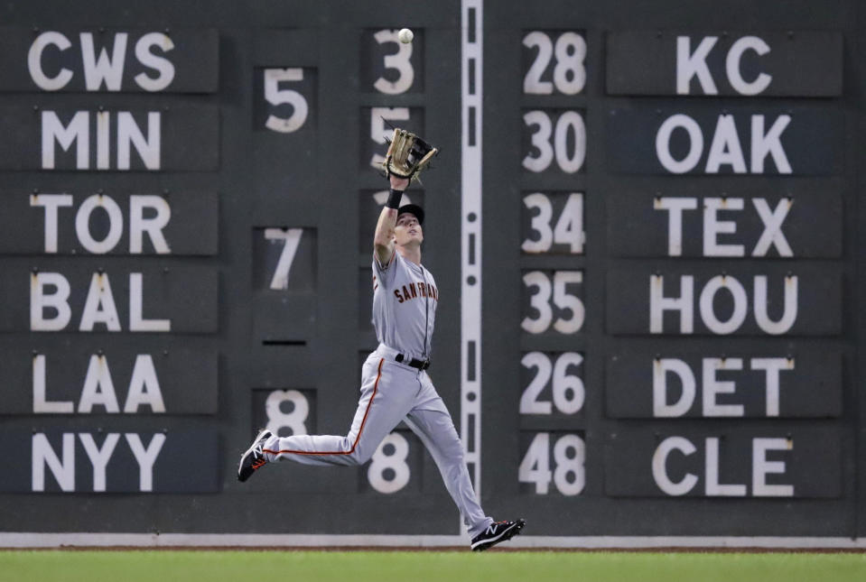 San Francisco Giants left fielder Mike Yastrzemski fields a fly out by Boston Red Sox's Andrew Benintendi during the sixth inning of a baseball game at Fenway Park in Boston, Tuesday, Sept. 17, 2019. (AP Photo/Charles Krupa)