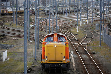 Employees of French state-owned railway company SNCF work at a rail station in Nantes, France March 20, 2018. REUTERS/Stephane Mahe