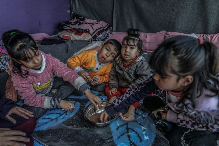 Niños palestinos desplazados en una carpa en Rafah el 19 de febrero de 2024.