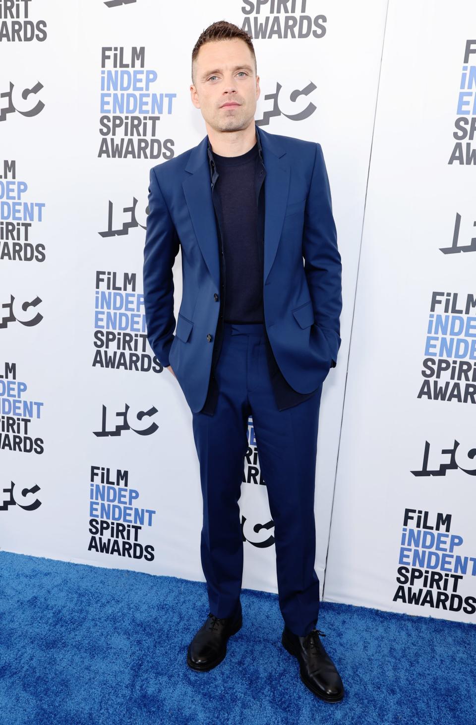 Sebastian wears a navy suit