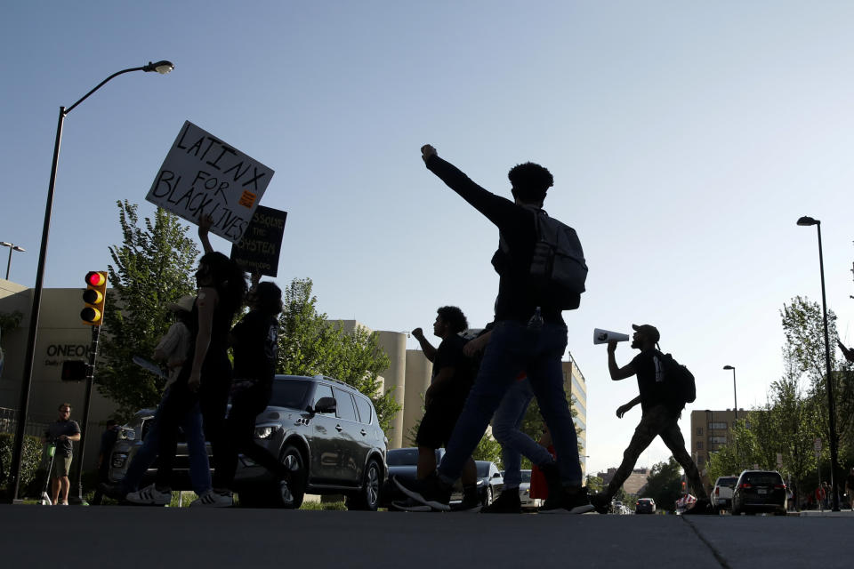 Demonstrators march near the BOK Center where President Trump will hold a campaign rally in Tulsa, Okla., Saturday, June 20, 2020. (AP Photo/Charlie Riedel)