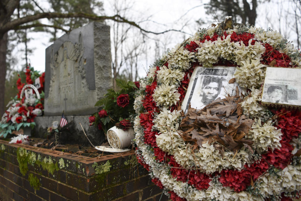 In this Feb. 16, 2020, photo, wreaths and mementos adorn the grave of Jimmie Lee Jackson at Heard Cemetery in Marion, Ala. In 1965, in what has become a footnote to history, Jimmie Lee Jackson was fatally shot at a protest in Marion. It was that killing that sent hundreds of people to Selma for a march at the Edmund Pettus Bridge two weeks later.(AP Photo/Julie Bennett)
