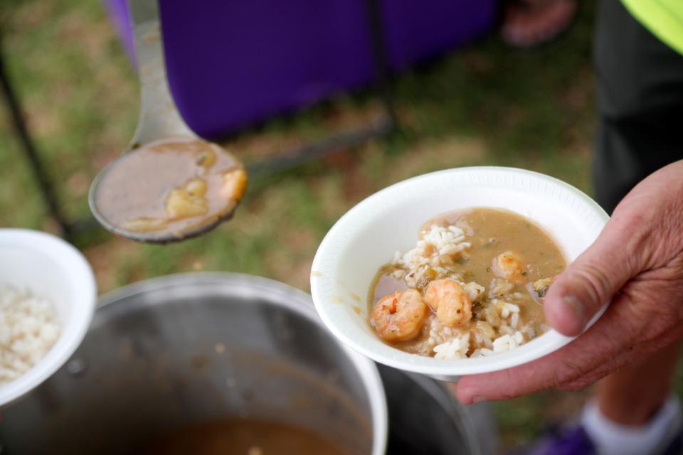 LSU fans dish out food as they tailgate before a softball game between Tennessee and Alabama in the Women's College World Series at USA Softball Hall of Fame Stadium in Oklahoma City, Thursday, June 1, 2023. 