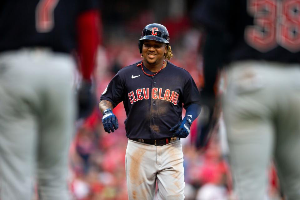 Cleveland Guardians third baseman Jose Ramirez (11) smiles as he crosses home plate after hitting a grand slam in the ninth inning of the MLB interleague game  at Great American Ball Park in Cincinnati, Tuesday, April 12, 2022. Cleveland Guardians defeated Cincinnati Reds 10-5.