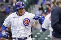 Chicago Cubs' Anthony Rizzo, left, smiles as he celebrates with Joc Pederson after hitting a solo home run during the first inning of a baseball game against the Atlanta Braves in Chicago, Sunday, April 18, 2021. (AP Photo/Nam Y. Huh)