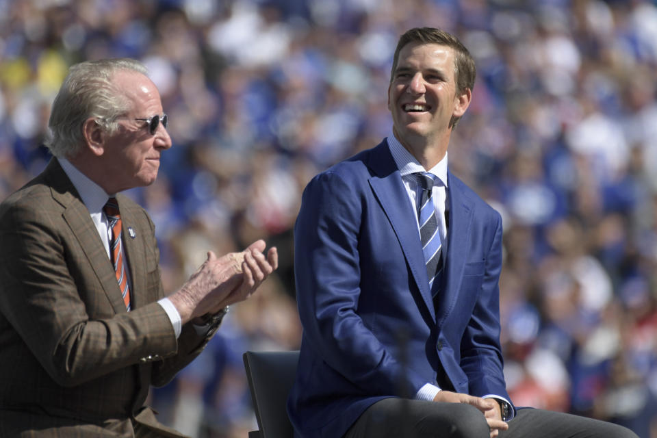 Former New York Giants quarterback Eli Manning smiles while he attends a ceremony to retire his jersey number 10 and celebrate his tenure with the team during half-time of an NFL football game against the Atlanta Falcons, Sunday, Sept. 26, 2021, in East Rutherford, N.J. (AP Photo/Bill Kostroun)