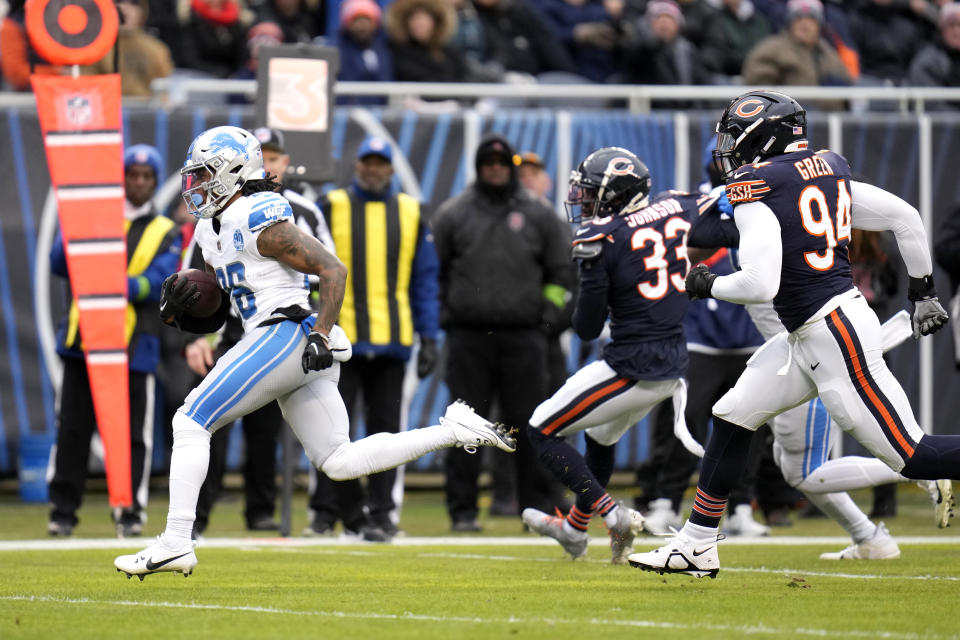 Detroit Lions running back Jahmyr Gibbs heads to the end zone past Chicago Bears cornerback Jaylon Johnson (33) and defensive end Rasheem Green for a touchdown during the first half of an NFL football game Sunday, Dec. 10, 2023, in Chicago. (AP Photo/Erin Hooley)