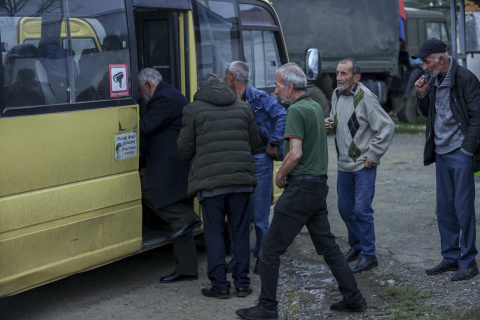 Ethnic Armenian men from Nagorno-Karabakh get on a bus to Armenia's Goris, in Lissagorsk village, Azerbaijan, Sunday, Oct. 1, 2023. The last bus carrying ethnic Armenians from Nagorno-Karabakh has left the region, completing a weeklong, grueling exodus in which more than 80% of its residents have fled after Azerbaijan reclaimed the area in a lightning military operation. (AP Photo/Aziz Karimov)