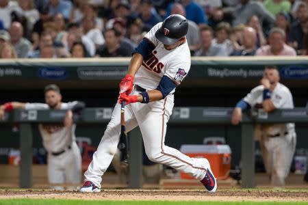 Jul 9, 2018; Minneapolis, MN, USA; Minnesota Twins third baseman Eduardo Escobar (5) hits a RBI single during the seventh inning against the Kansas City Royals at Target Field. Mandatory Credit: Jordan Johnson-USA TODAY Sports