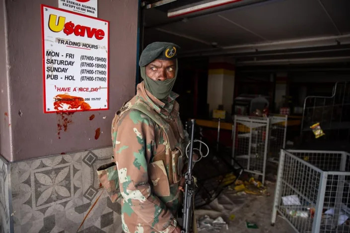A South African soldier responds to looting on July 13, 2021 at a shopping centre in Soweto, Johannesburg, South Africa. South Africa has deployed the military to quell spasms of civil unrest and looting sparked by last week’s imprisonment of former president Jacob Zuma. The unrest is also fueled by high unemployment and social and economic fallout from the Covid-19 pandemic, which has hit the country hard. (Photo by James Oatway/Getty Images)