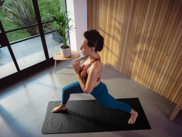 Girl Sitting on Rock by Water Falls Yoga Mat