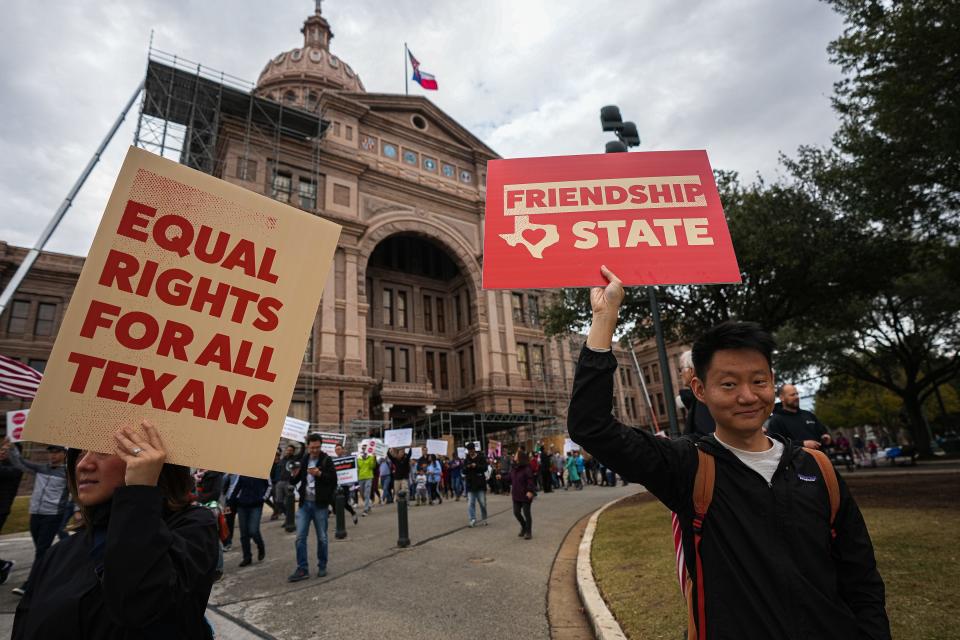 Hua Liu participates in a march in opposition to Senate Bill 147 at the Capitol on Sunday. The bill would ban the purchase of Texas land by companies, government agencies and citizens of China, Iran, North Korea and Russia.