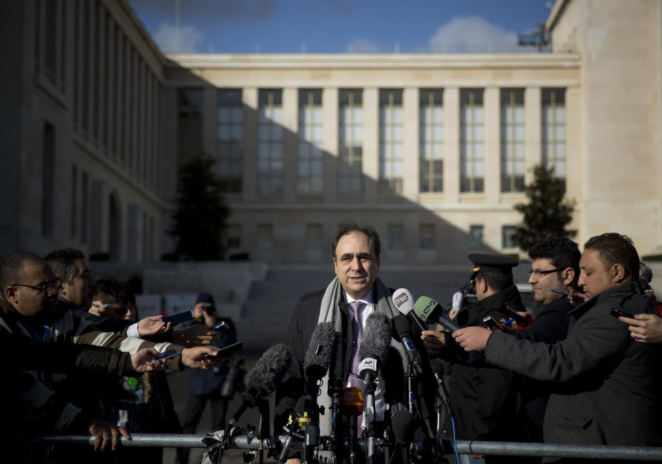 Monzer Akbik, center, a Syrian opposition spokesman, briefs journalists at the United Nations headquarters in Geneva, Switzerland, Switzerland, Monday, Jan. 27, 2014. Akbik said the coalition was still determined to stay for the political talks set to begin Monday despite accusing the government of stalling. (AP Photo/Anja Niedringhaus)