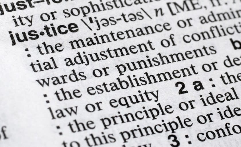 In this Dec. 12, 2018, photo, "justice" is displayed in a Merriam-Webster dictionary in New York. Merriam-Webster has chosen "justice" as its 2018 word of the year, driven by the churning news cycle and President Trump's Twitter feed. (AP Photo/Mark Lennihan)