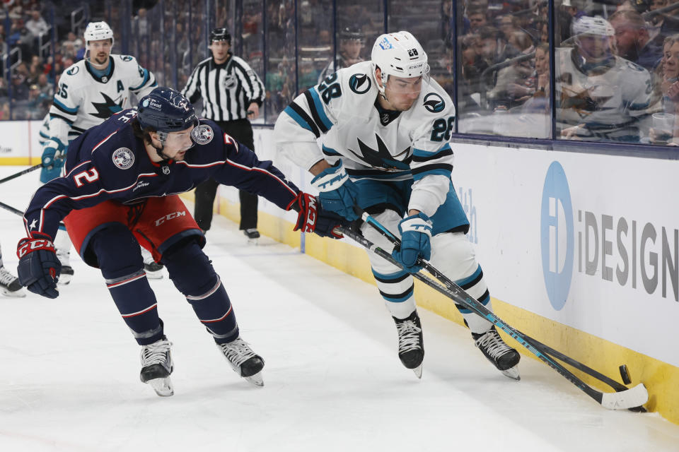 Columbus Blue Jackets' Andrew Peeke, left, and San Jose Sharks' Timo Meier chase a loose puck during the first period of an NHL hockey game on Saturday, Jan. 21, 2023, in Columbus, Ohio. (AP Photo/Jay LaPrete)