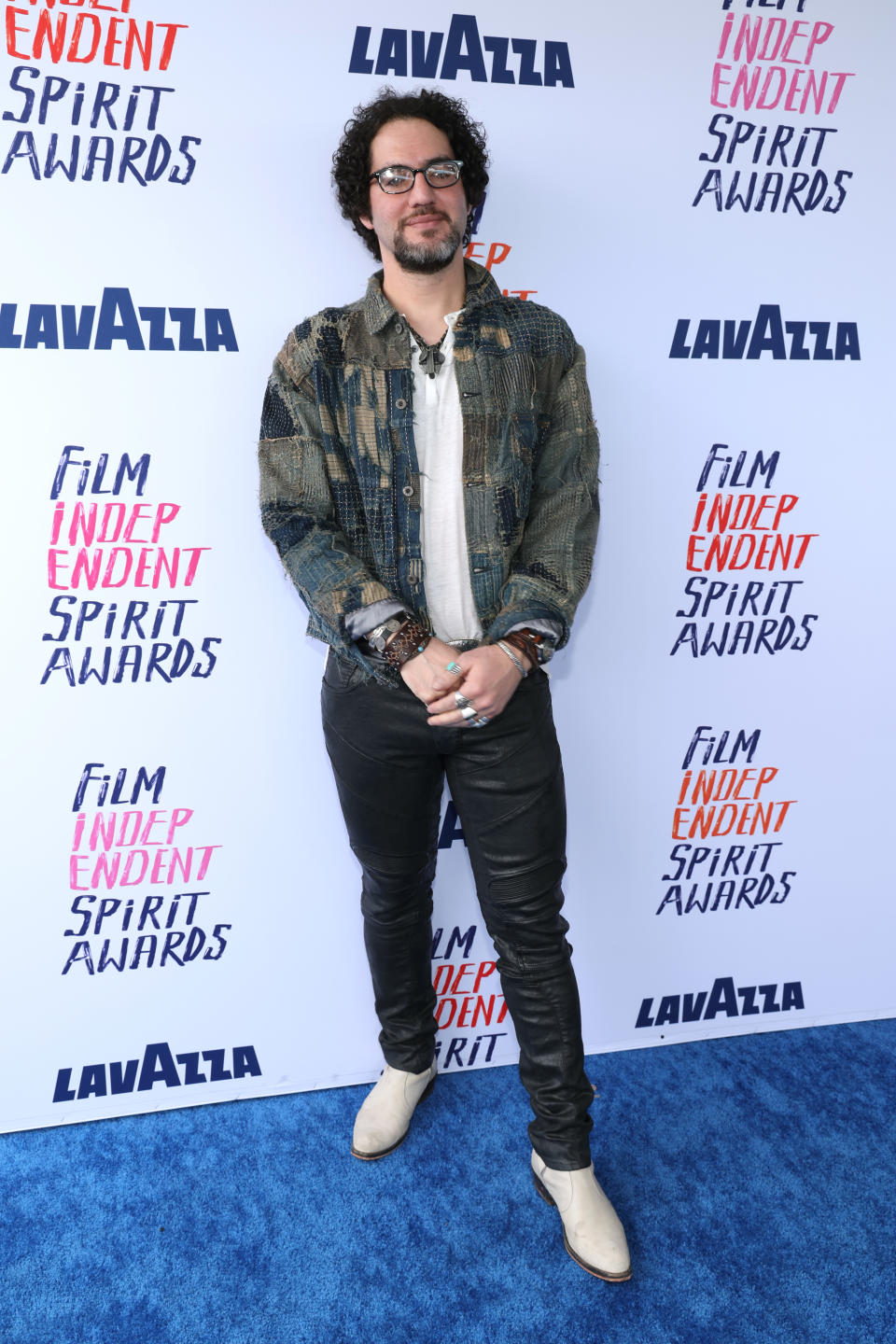 Benny Safdie in patterned jacket and light pants