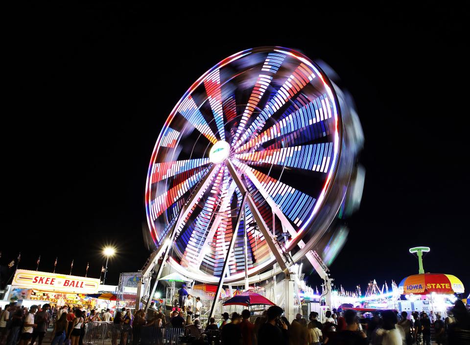 The giant Ferris wheel spins at Thrill Ville during East Side Night on Friday, Aug. 11, 2023, at the Iowa State Fair in Des Moines.