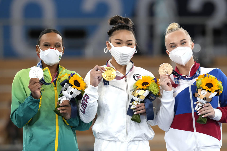 From left: Silver medalist Brazil’s Rebeca Andrade, Gold medalist Sunisa Lee of the U.S., and bronze medalist Angelina Melnikova, of the Russian Olympic Committee, celebrate during the medal ceremony for the artistic gymnastics women’s all-around at the 2020 Summer Olympics, on July 29, 2021, in Tokyo. (AP Photo/Gregory Bull) - Credit: AP