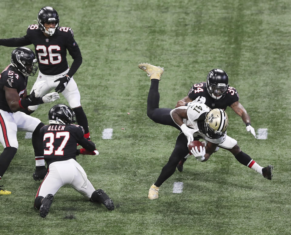 New Orleans Saints running back Alvin Kamara dives into the endzone past Atlanta Falcons cornerback Darqueze Dennard for a touchdown during the second half of an NFL football game on Sunday, Dec. 6, 2020, in Atlanta. (Curtis Compton/Atlanta Journal-Constitution via AP)