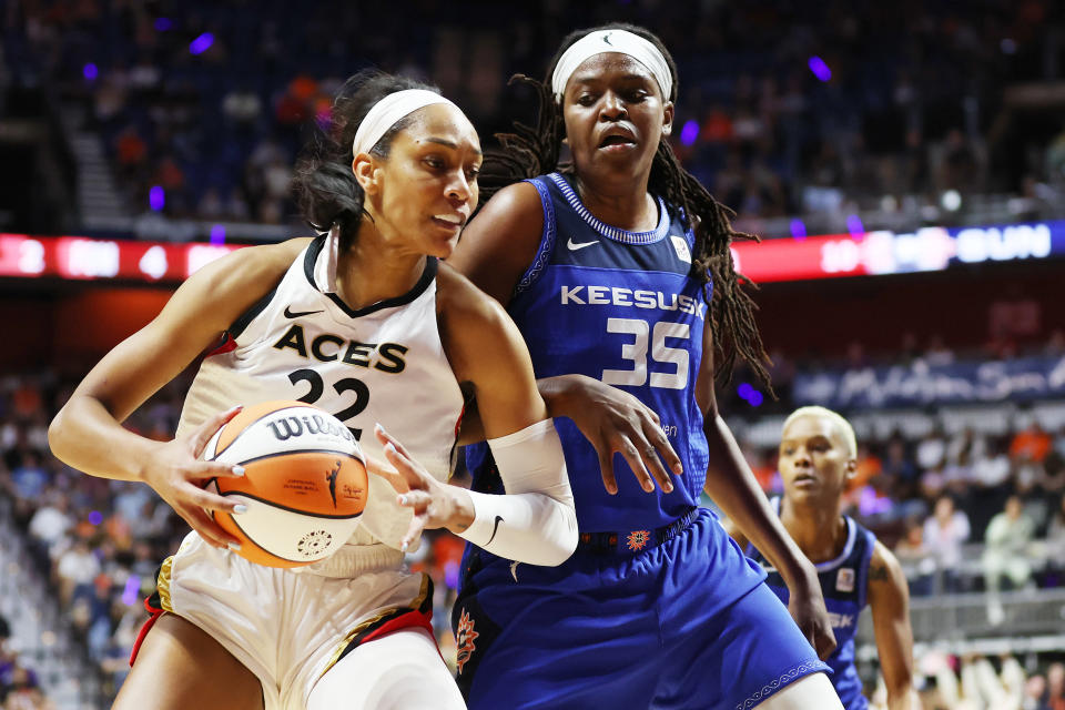 Las Vegas Aces forward Aja Wilson handles the ball against Connecticut Sun forward Jonquel Jones during Game 4 of the 2022 WNBA Finals at Mohegan Sun Arena in Uncasville, Connecticut, on Sept.  18, 2022. (Maddie Meyer/Getty Images)
